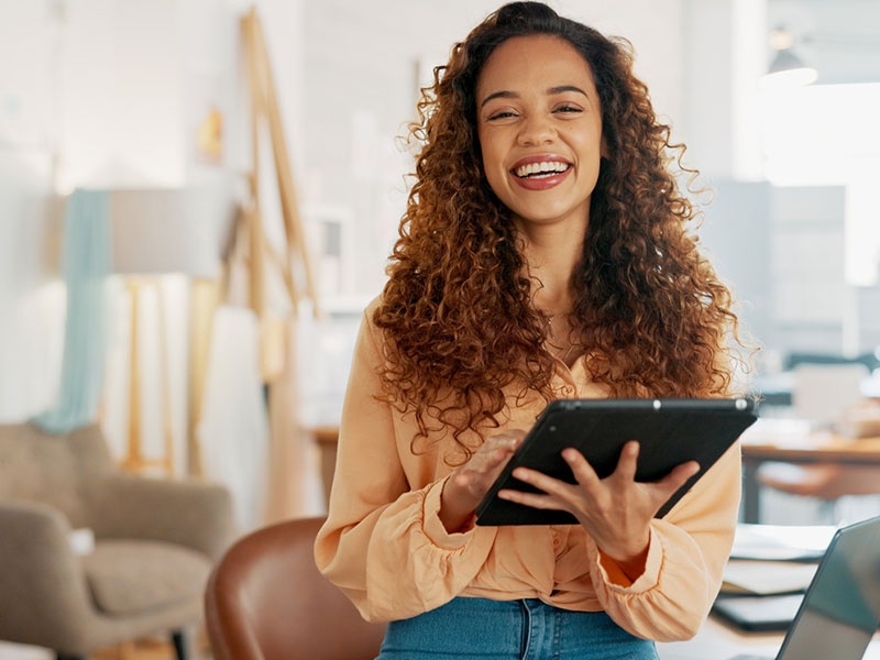 Portrait, tablet and black woman designer in an office for planning, strategy or creative research. Technology, smile and online order with a young employee or small business owner in a workplace stock photo