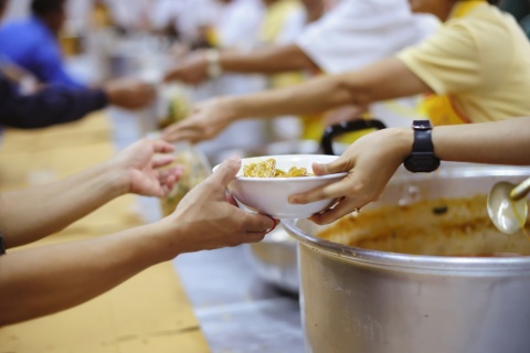 bowl of food passing between hands