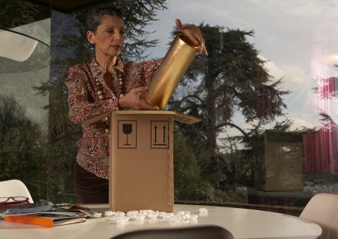 woman unpacking piece of art