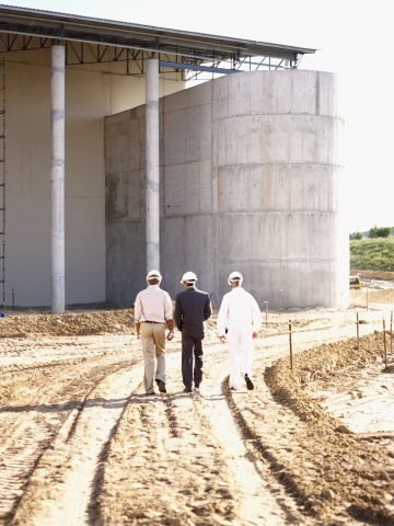 architects walking toward unfinished building