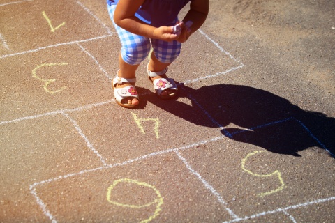 child playing hopscotch
