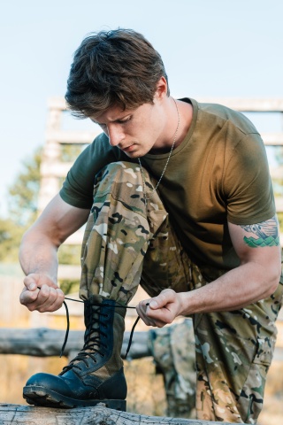 soldier tying boot