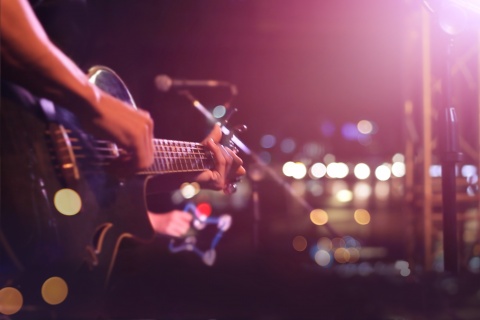 man playing guitar on stage