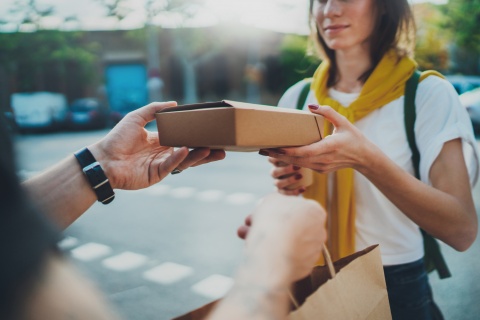 man handing woman package