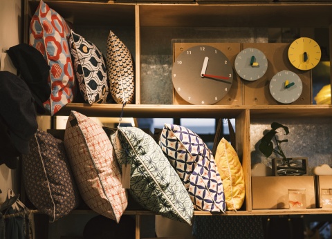 pillows and rugs on shelves