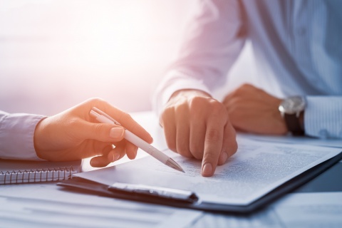 two people with legal piece of paper